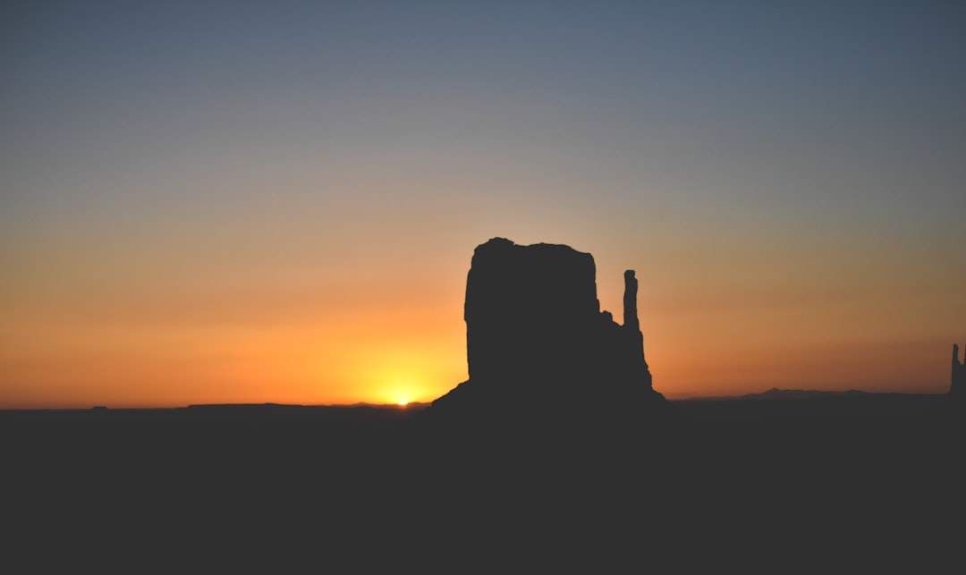 silhouette of rock formation during golden hour