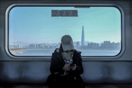 woman wearing coat and earbuds
