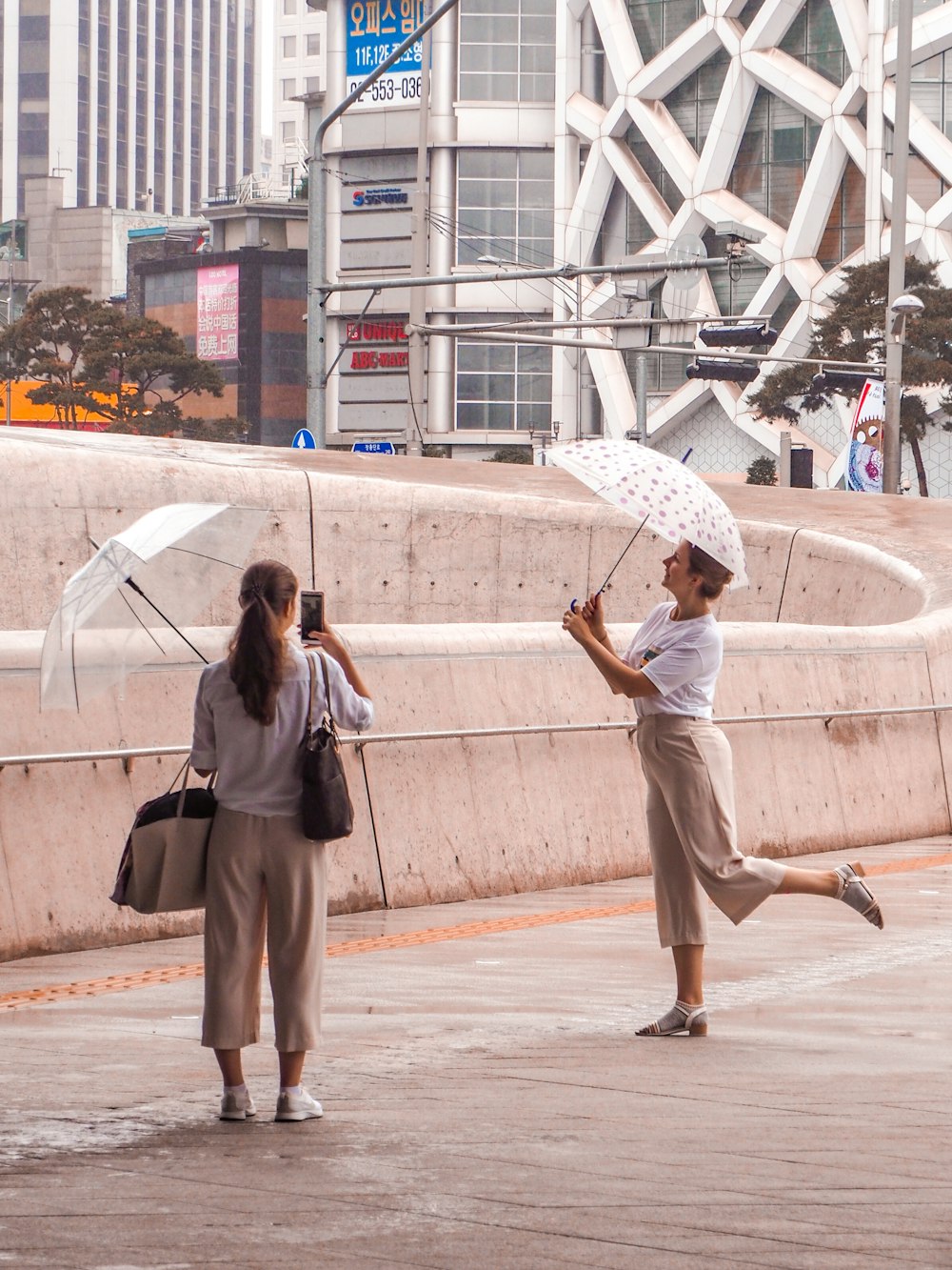 woman holding white umbrella