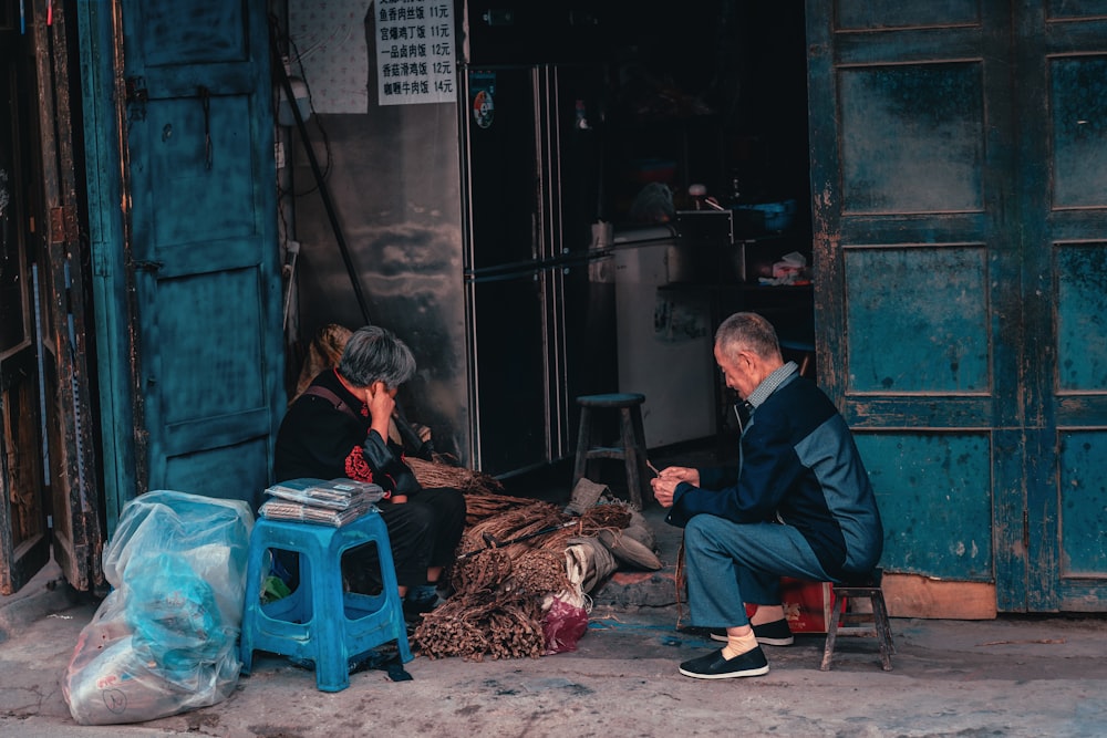 man sitting in front of woman