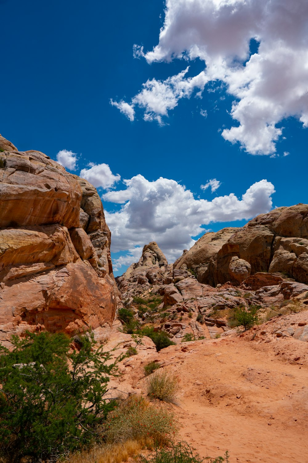 brown rock formations under white and blue skies