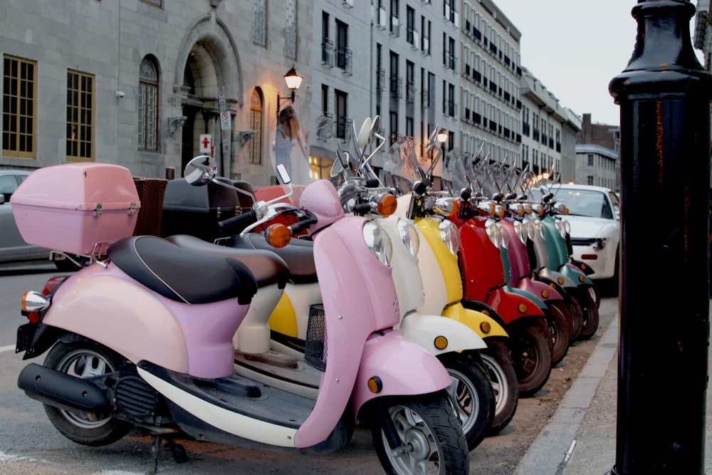 assorted-color motor scooters parkes outside building