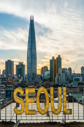 A panoramic view of Seoul’s city skyline lit up under the night sky with Namsan Tower shining