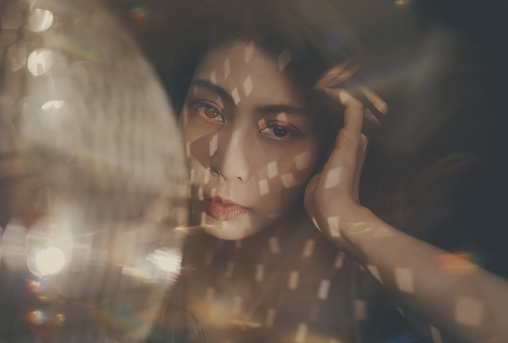 woman posing near mirror ball