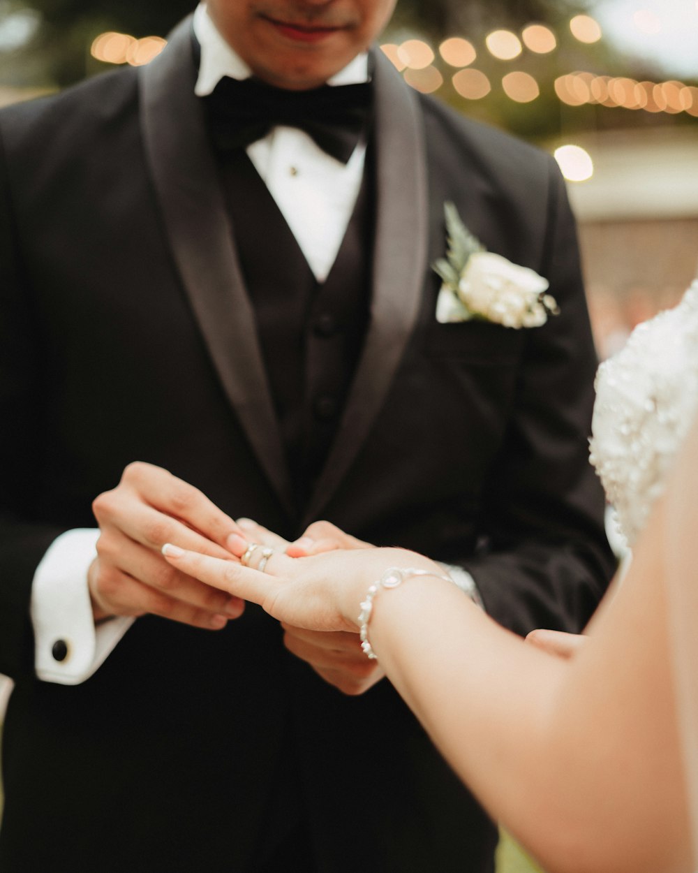 groom putting ring on his bride