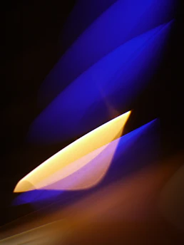 Abstract geometric shapes in navy blue and muted pastels flowing with dynamic light and shadow effects.