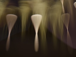 a group of white vases sitting on top of a table