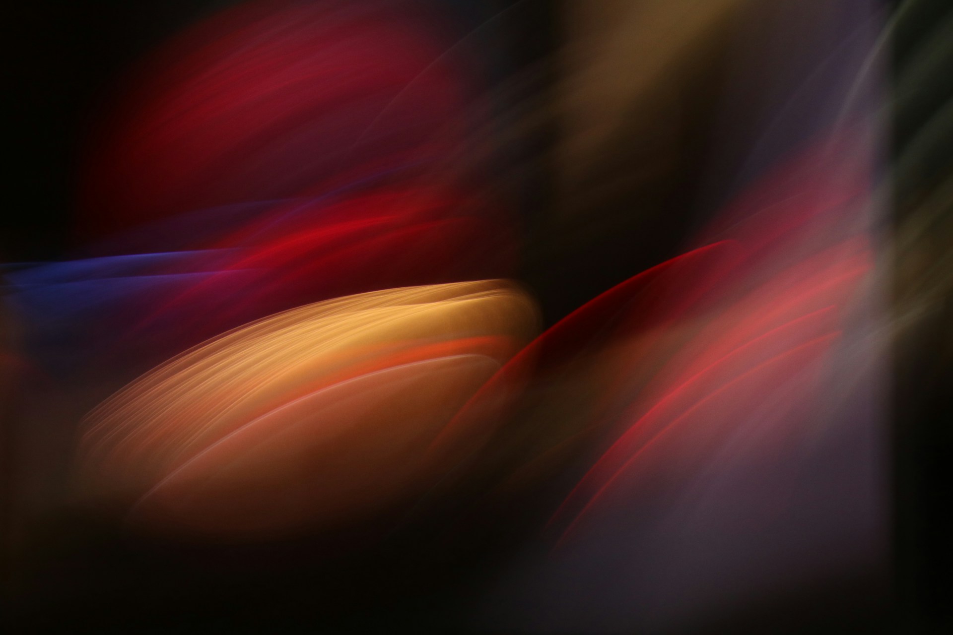 a blurry image of a red, yellow, and blue object