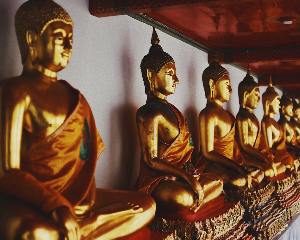 gold-colored buddha figurines