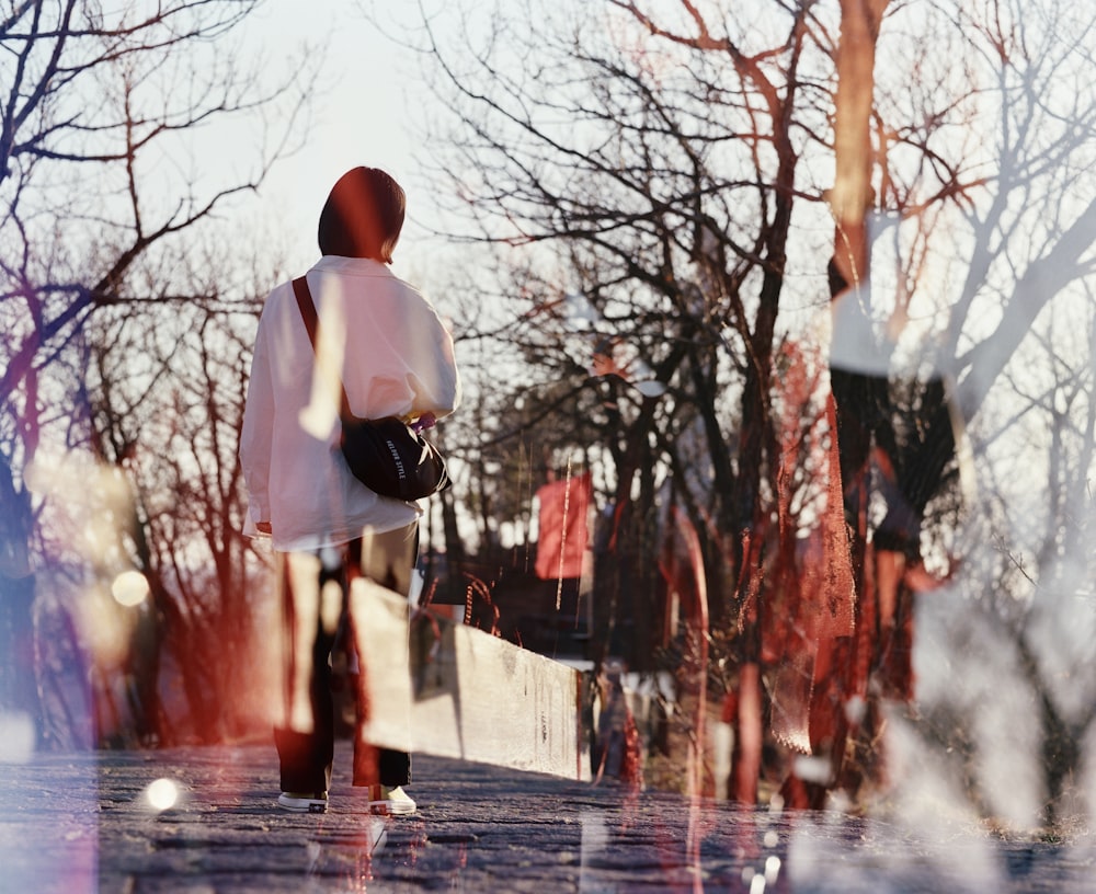 woman standing near bare trees