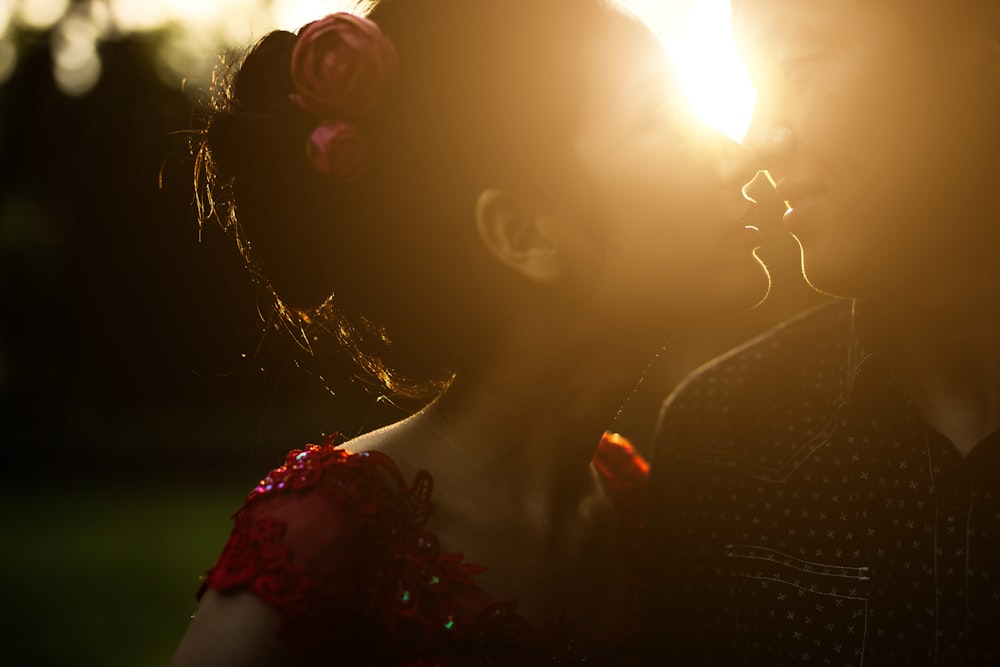 woman about to kiss man against sunlight