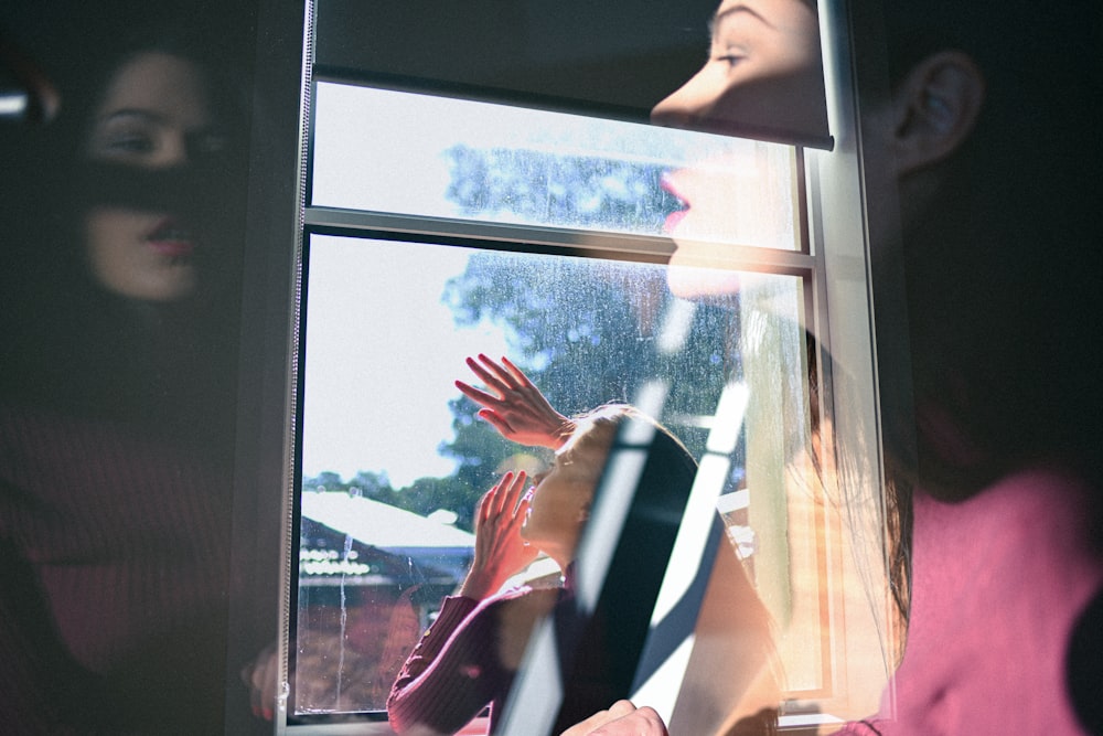 woman facing clear glass window