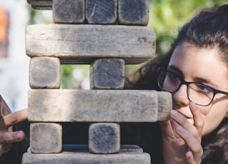 woman playing with wooden blocks