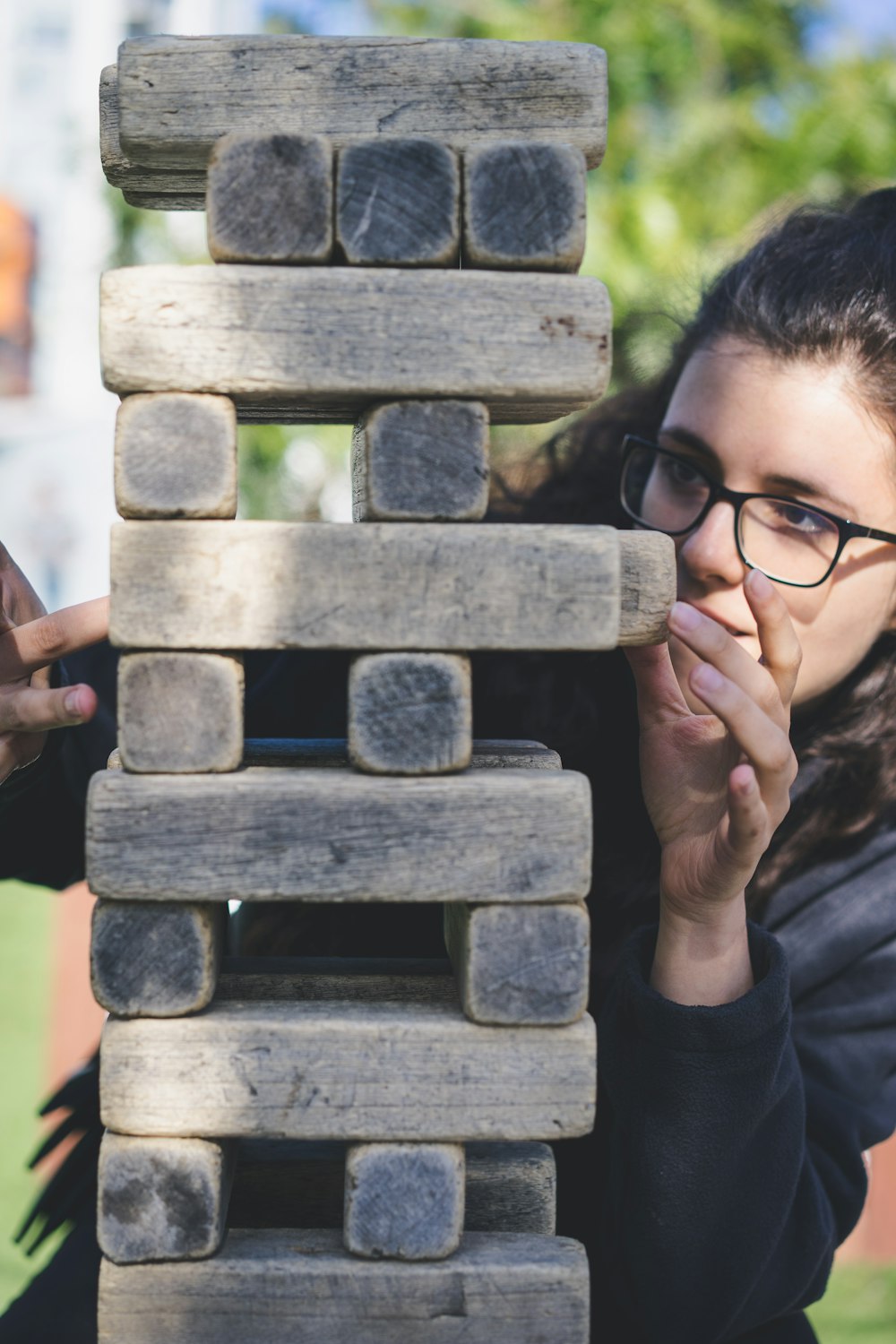 woman playing with wooden blocks