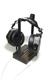 Stylish headset with cushioned ear pads resting on a minimalist stand