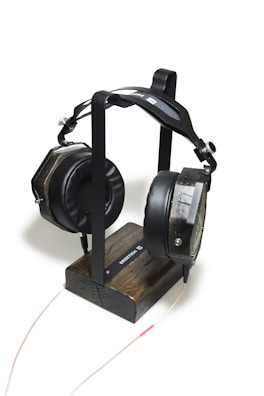 Side view of Koira headset resting on a minimalist stand.