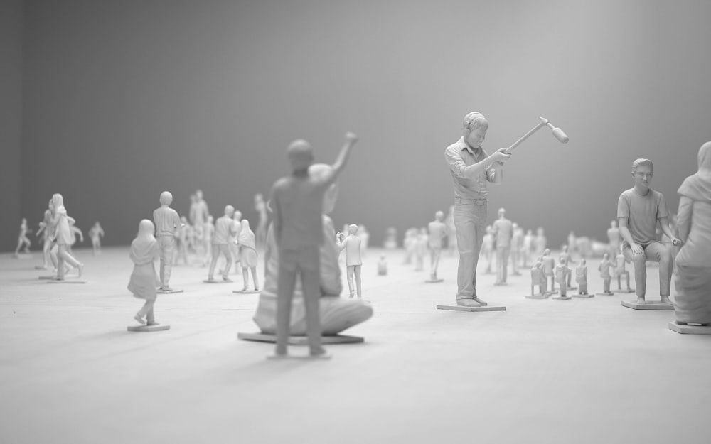 people figurines on white surface