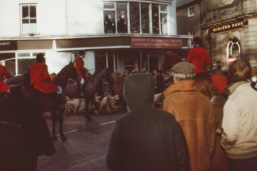 people standing near people riding horses