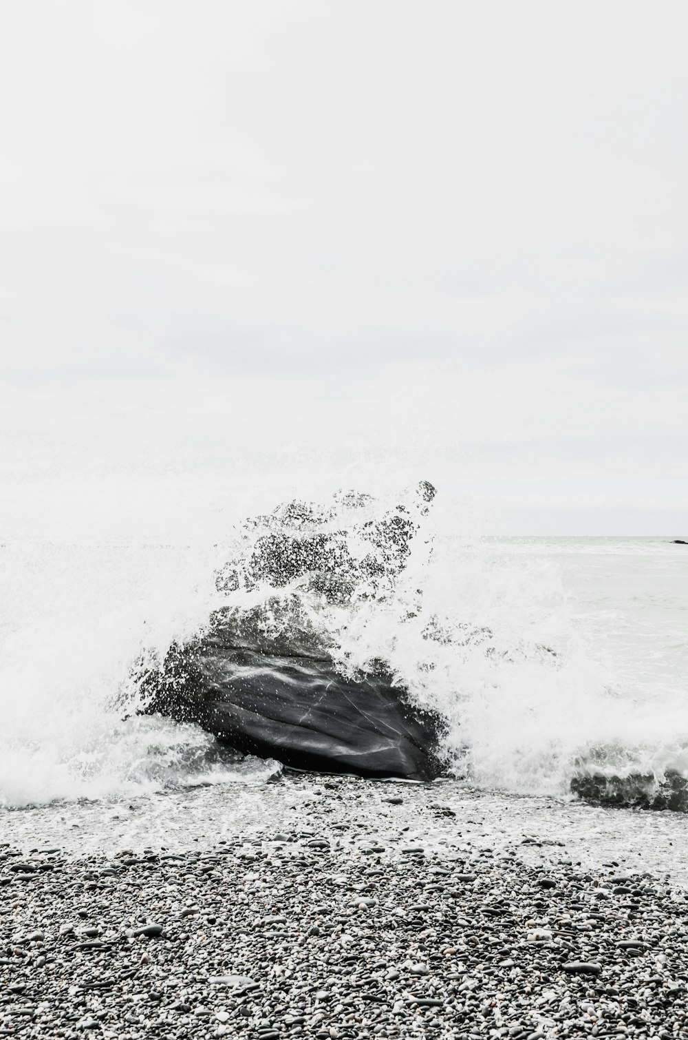 time lapse photography of wave splashing on rock