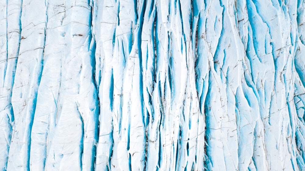 a close up of a blue and white textured wall