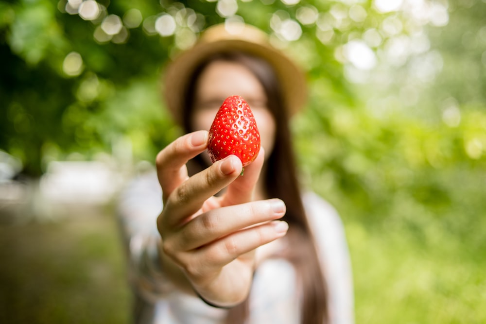 woman holding strawberry