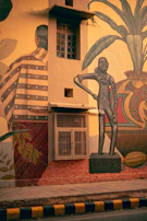 A colorful floral design painted alongside a home's address on a residential street curb.