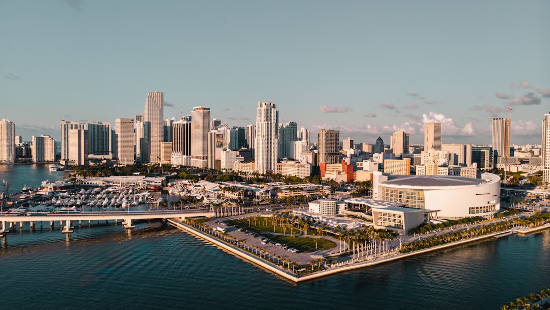 city skyline between sky and body of water,
