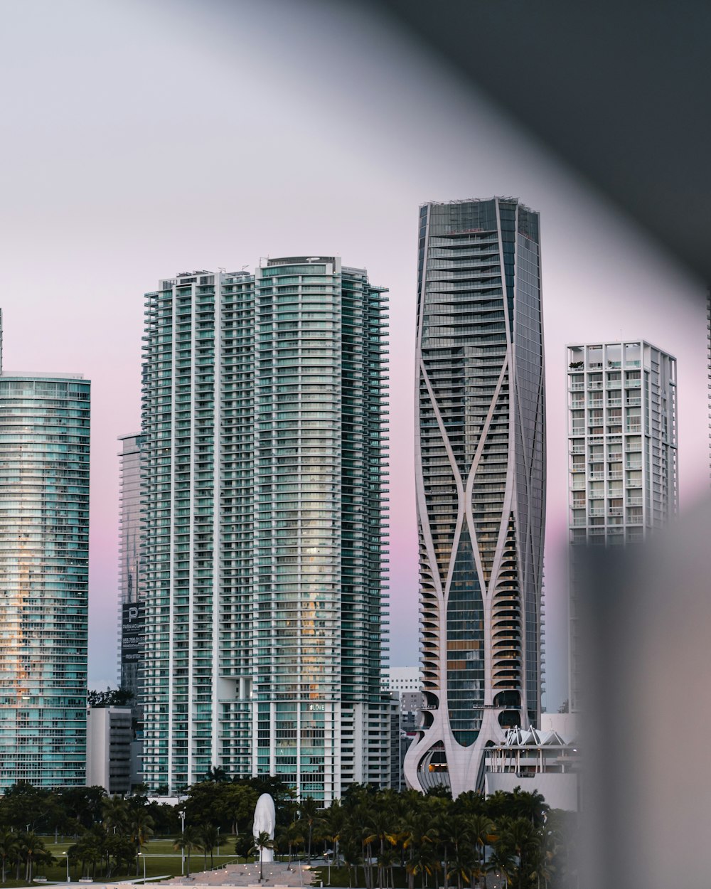 high rise buildings near trees