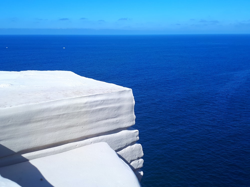 white snowy mountain cliff by the sea