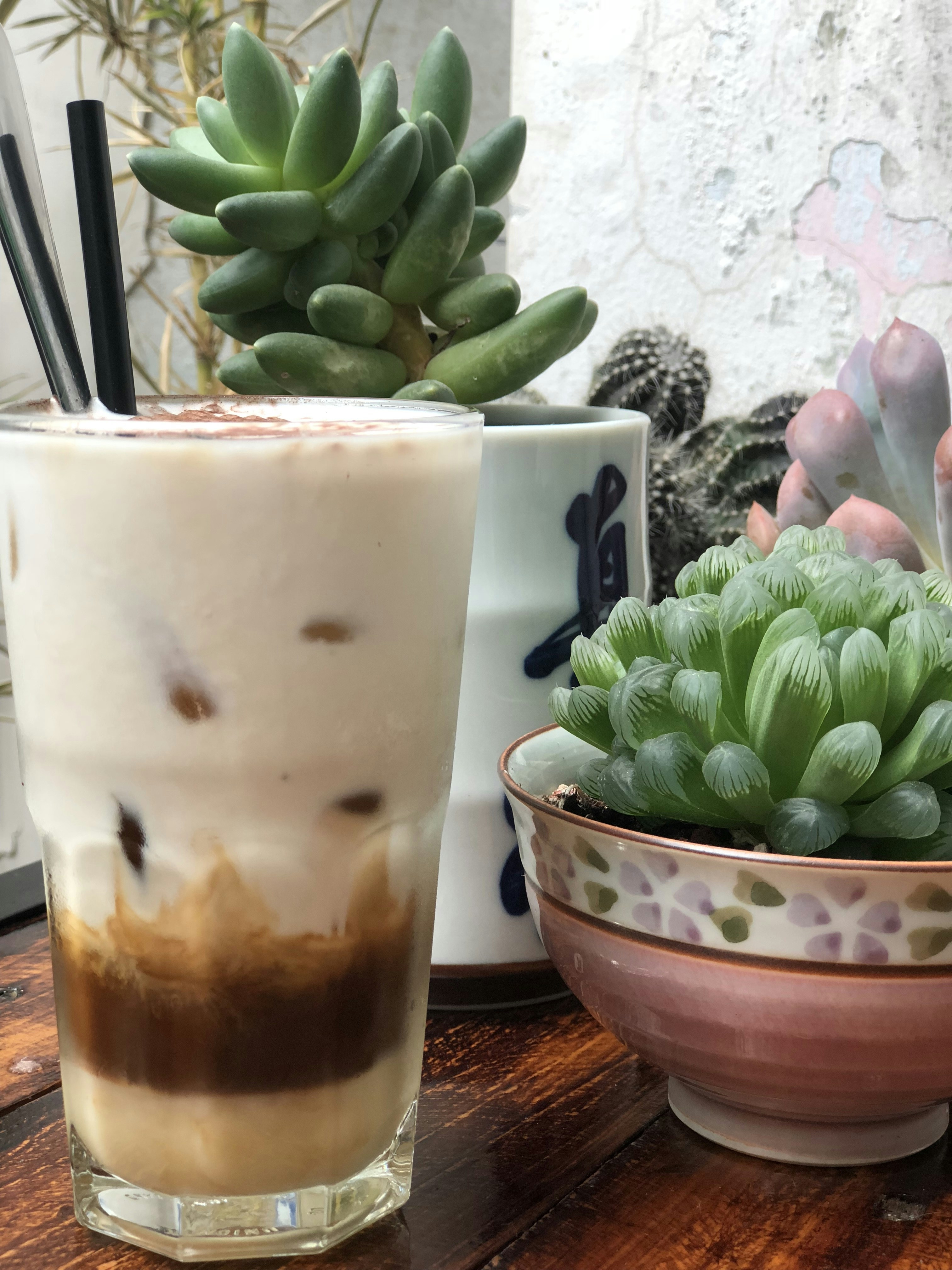 filled glass near plants