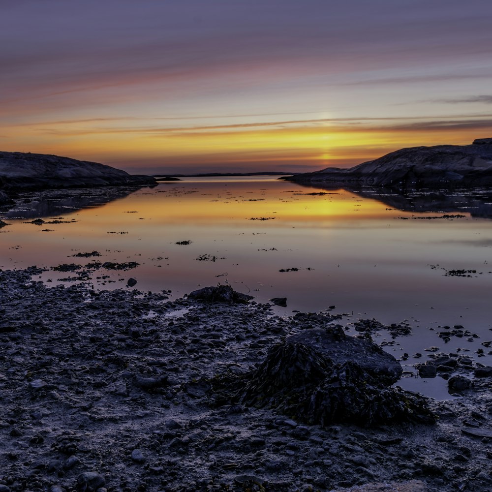 two black mountains near body of water