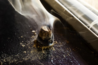 Incense cones burning quietly beside a serene window with morning light streaming in.