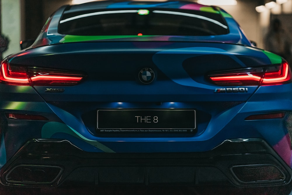 blue BMW car with THE 8 license plate