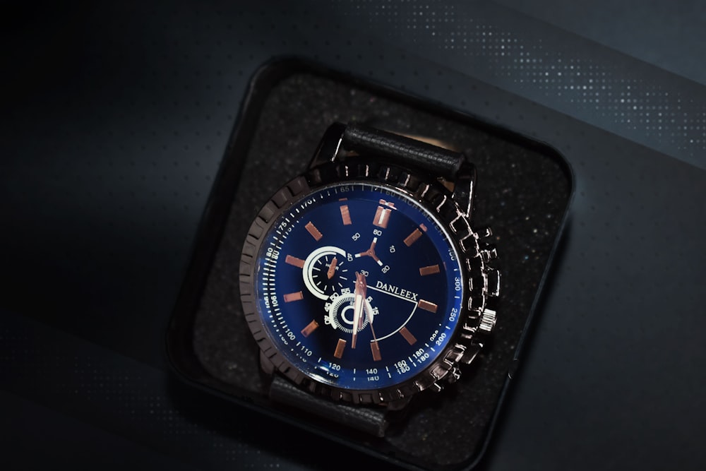 round black chronograph watch with black case