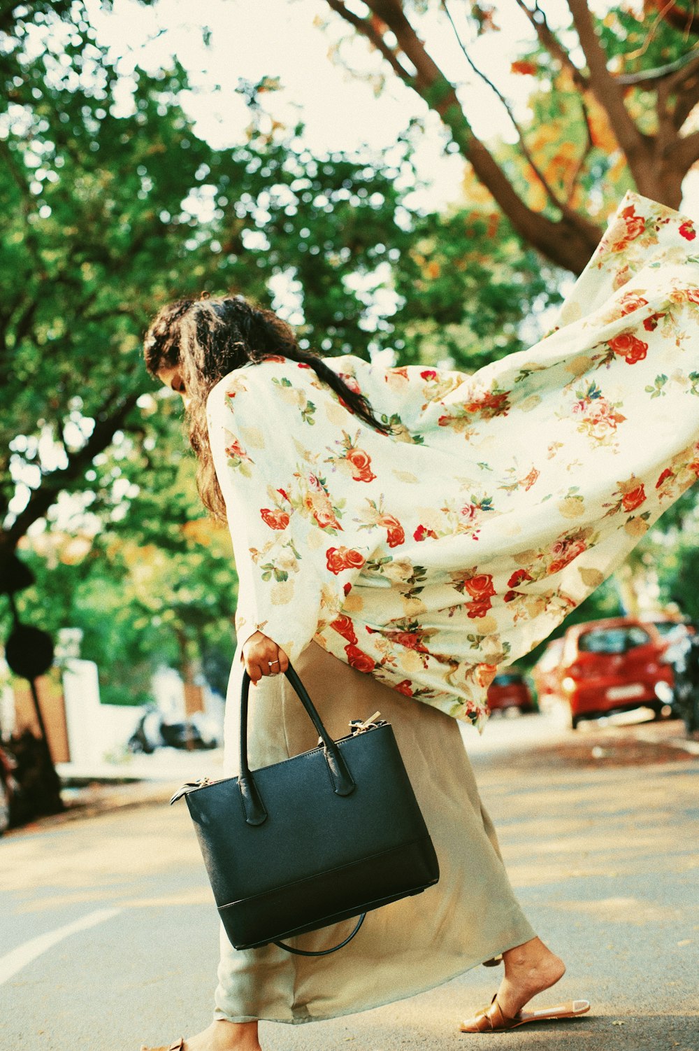 woman carrying black leather tote bag