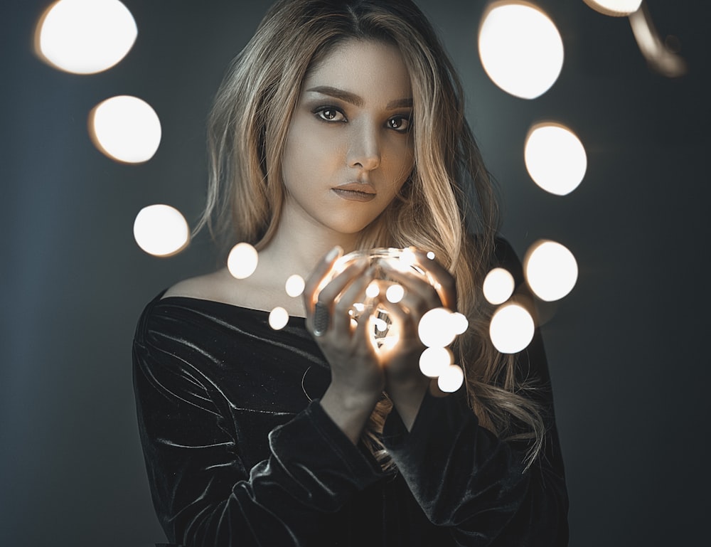 woman holding string LED light