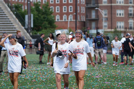 A vibrant photo of students celebrating a sports victory on the school field.