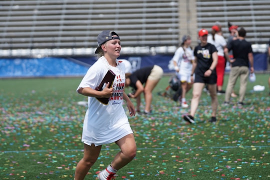 A joyful winner holding a large prize check with confetti falling around.