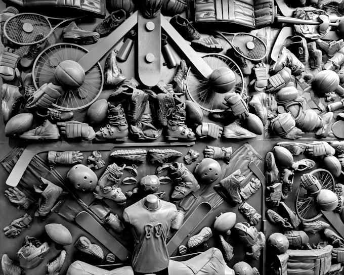 A vibrant collection of various sports equipment showcasing cricket bats, footballs, and badminton rackets.