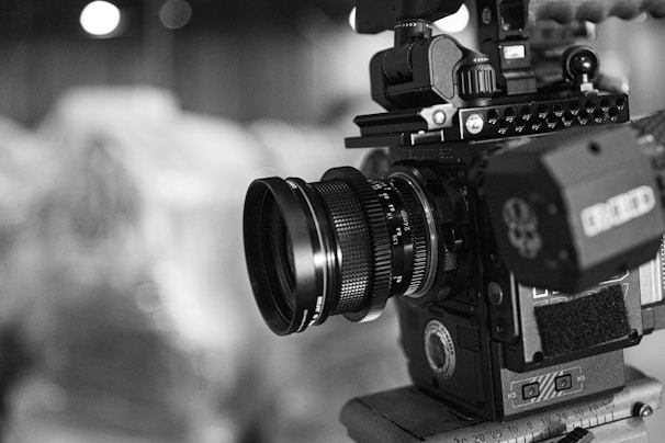 Close-up of a professional camera capturing a corporate event in black and white.