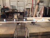 Softly lit workspace with macramé tools, colorful threads, and authentic Mexican stones scattered around.