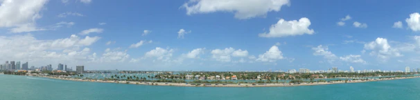A diverse remote team collaborating over video call with Panama City skyline visible on their screens.