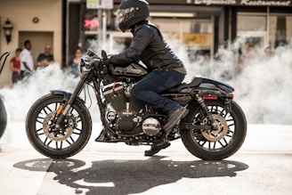 person wearing jacket and helmet riding motorcycle