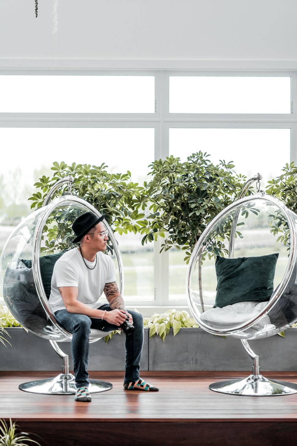 man sitting on clear acrylic chair