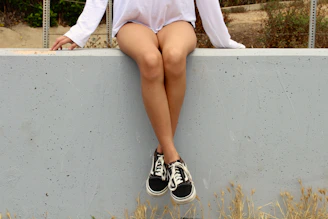 woman wearing black Vans Old Skool shoes