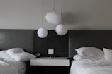 A contemporary bedroom setup featuring a simple bed frame and matching nightstands.