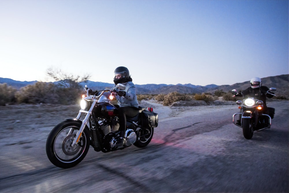 two persons riding motorcycles