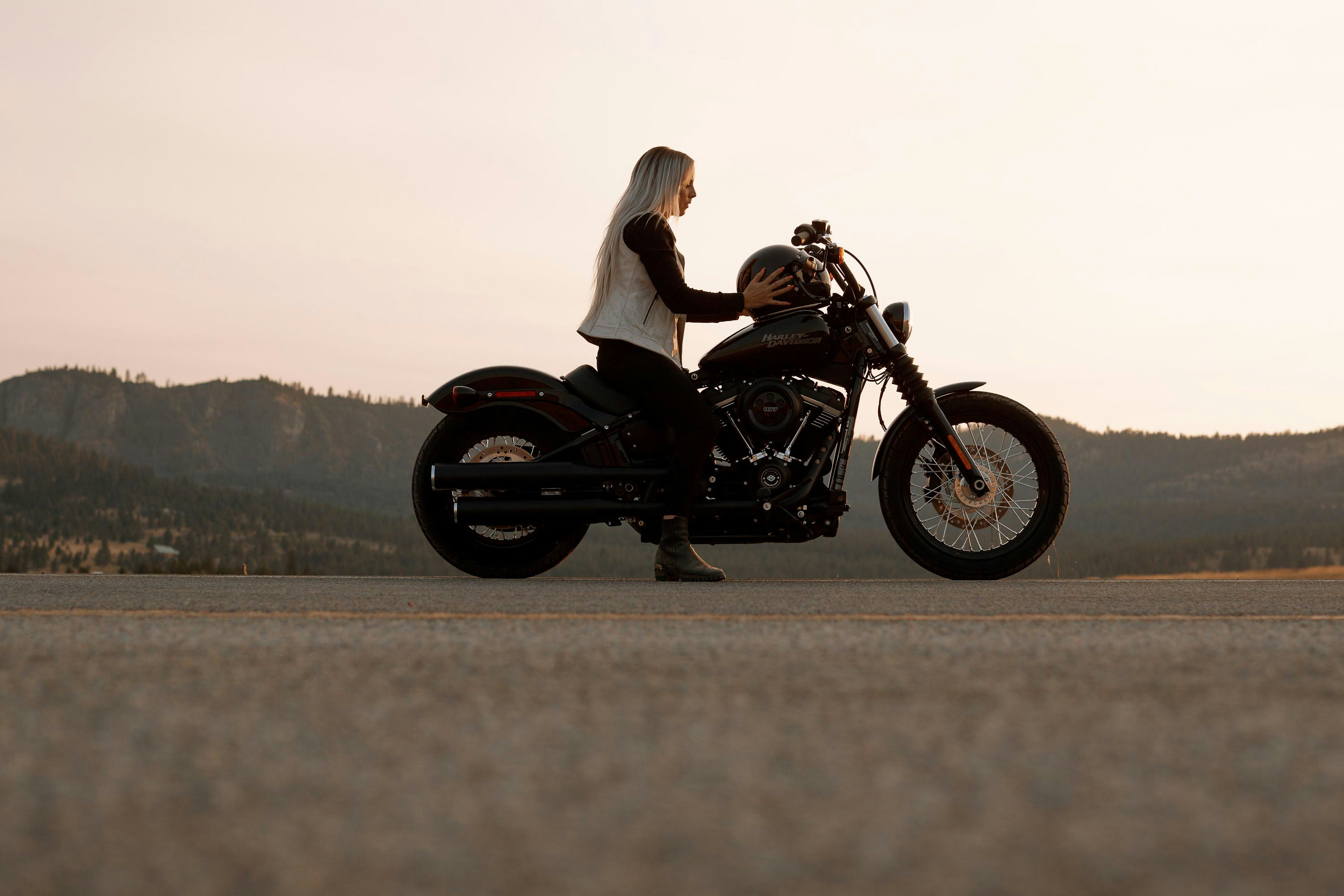 woman sitting on black and gray cruiser motorcycle