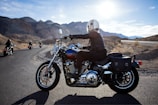 man riding touring motorcycle during daytime