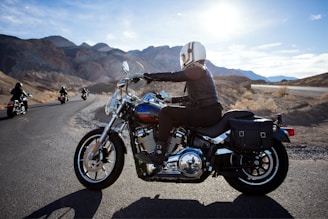 man riding touring motorcycle during daytime